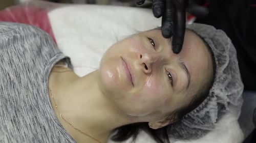 Cosmetologist Applies Peeling Lotion on Woman Face in Beauty Clinic Salon