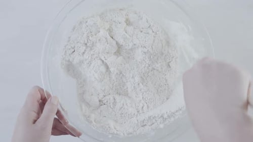 Hands Mixing Flour in Bowl for Baking