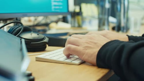 Man hands typing on a laptop computer keyboard