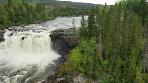 Majestic Waterfall Flowing Through Green Forest