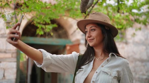 Woman Takes Photo with Phone Outside