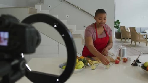 Woman Cuts Fruit in Modern Kitchen