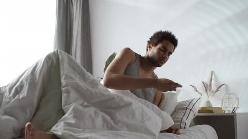 Young Man Wakes Up and Takes Medication