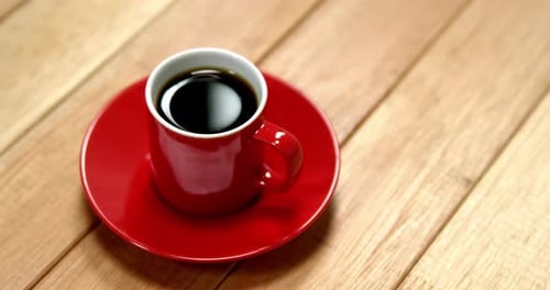 Red Cup of Coffee on Wooden Table