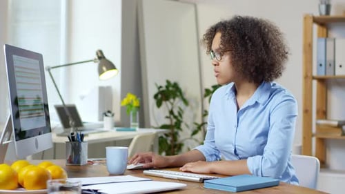 Young Black Businesswoman Smiling for Camera in Office