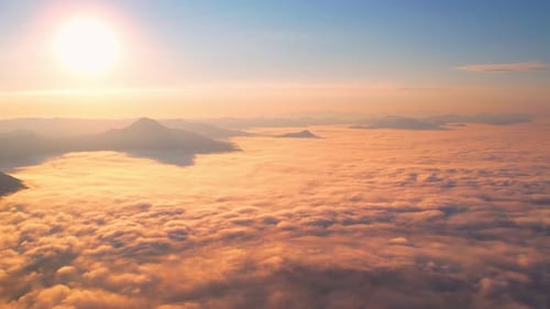 4K Aerial video Beautiful sunrise above dense clouds and fog in the morning