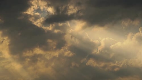 The Sun's Rays Make Their Way Through the Clouds. Time Lapse