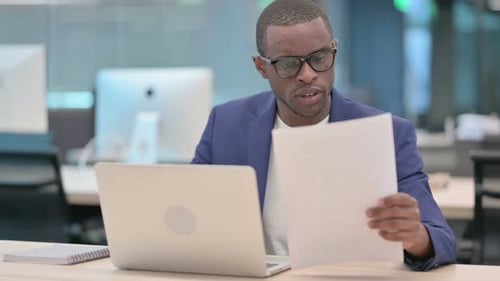 Man Working at Laptop in Modern Office