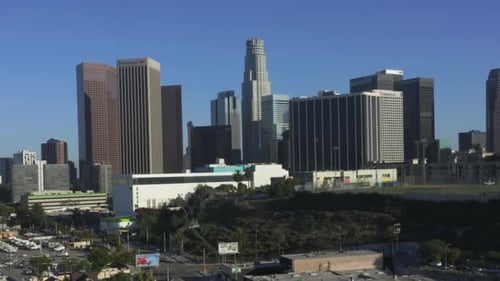 AERIAL: Flying Away From Downtown Los Angeles, California Skyline at Beautiful Blue Sky and Sunny