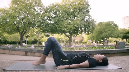 Asian woman exercise in park outdoor with new normal in COVID-19 situation