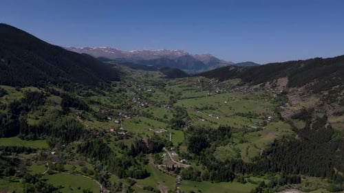 Picturesque Village Nestled in Lush Green Mountain Valley