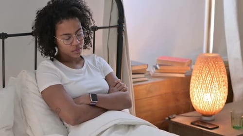 Sleepy African Woman Taking Nap in Bed