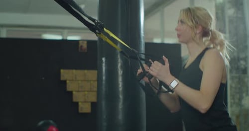 Sportswoman Doing Cardio Exercise with System in Loft Gym