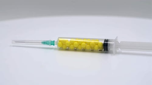 Medical Syringe Filled with Yellow Pills