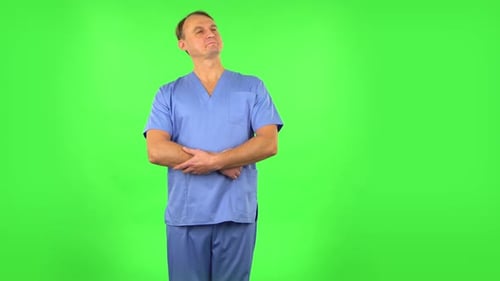 Medical Man Stands in Expectation Then Proudly Smiles. Green Screen