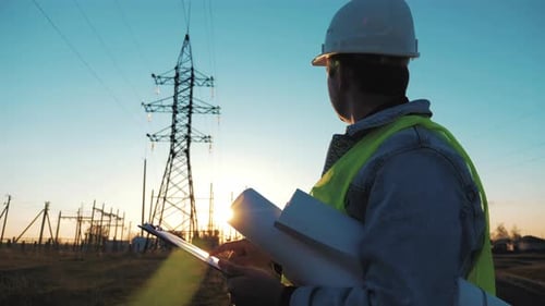 Architect Worker Checking Construction Project On Electric Tower