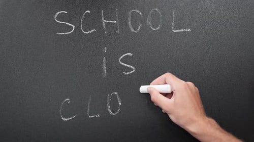 School is closed written on blackboard with chalk.