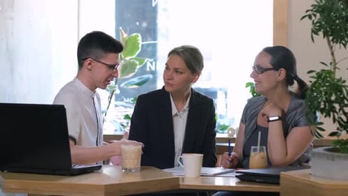 Business Colleagues Working in a Coffee Shop