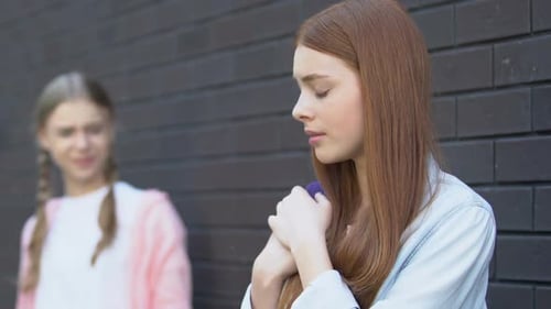 Teen Girl Laughing at Female Classmate
