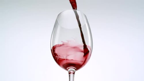 Red Wine Pouring Into Glass in Slow Motion