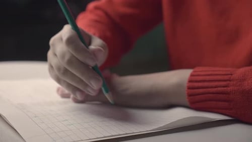 Asian girl is autistic doing homework and having awareness with behavior development disability.