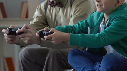 Grandfather and Grandson Play Video Game Together