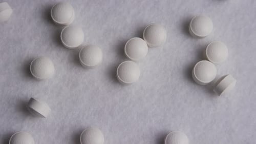 Close-Up of White Pills on Grey Background