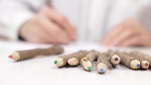 Hand Picks Up Red Wooden Colored Pencil