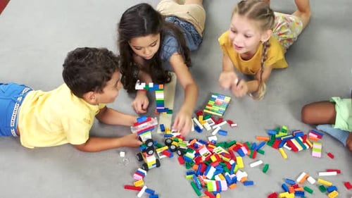 Children Playing with Colorful Interlocking Building Blocks
