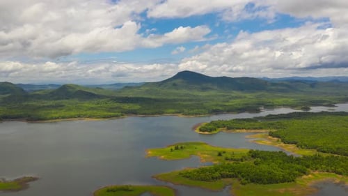 Aerial view, clouds moving over the mountains during the day,
