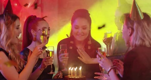 Women Celebrating Birthday with Champagne and Confetti