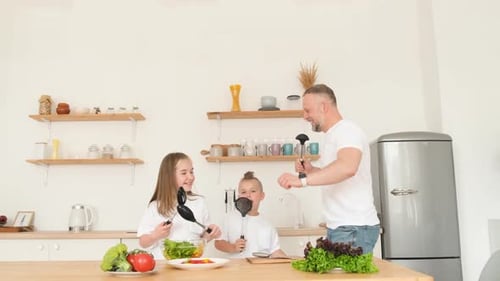 Dad and Kids Making Salad and Dancing