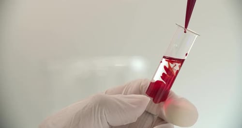 Red Liquid Being Added to Test Tube