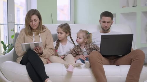 Family Using Technology Together on Couch