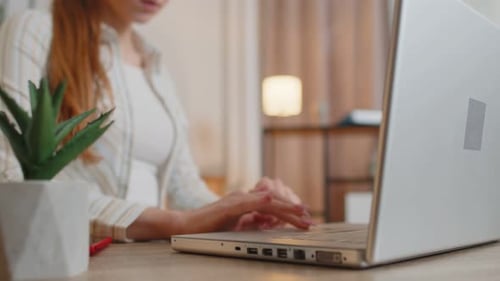 Young Woman Girl Using Laptop Computer Sitting at Table Working Typing on Keyboard From Home Office