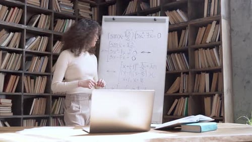 Woman Explaining Math Equations in Home Library