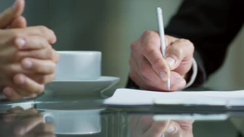 Hands of Businessman Writing on Document