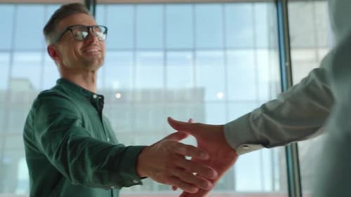 Businessmen Shaking Hands in Modern Office Environment