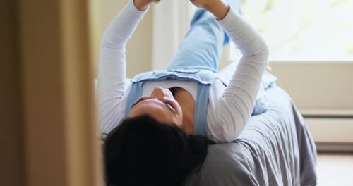 Woman Lying on Bed Using Mobile Phone