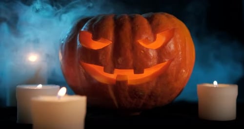 Glowing Jack-o'-Lantern with Candles and Smoke