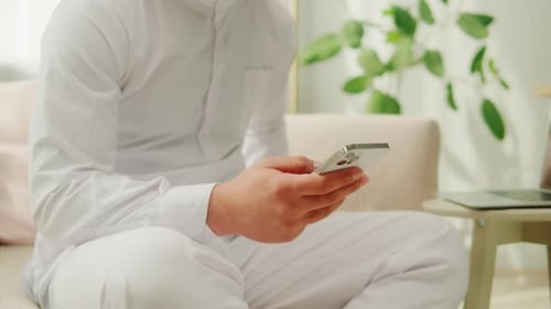 Man Using Phone in Home Setting