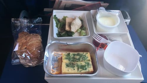 Close Up Breakfast Tray on Board the Flight Airplane Meal Omlette Yogurt