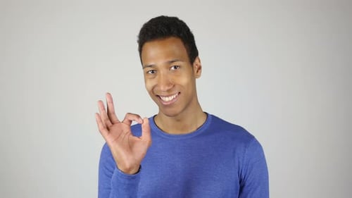 Young Adult Gives Approval with Okay Hand Gesture