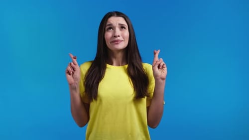 Woman Crossing Fingers Hoping for Good Luck