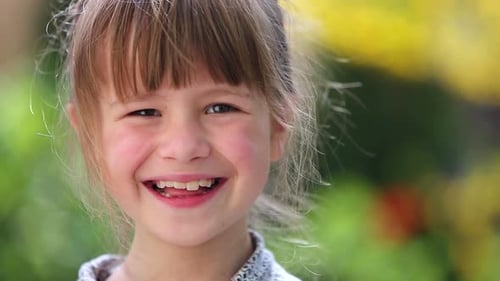 Smiling Girl with Brown Hair Close-Up in Nature