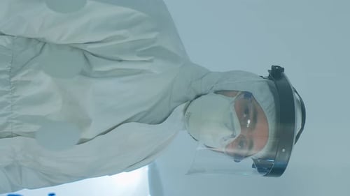 Scientist Protected in Hazmat Suit Working in Lab
