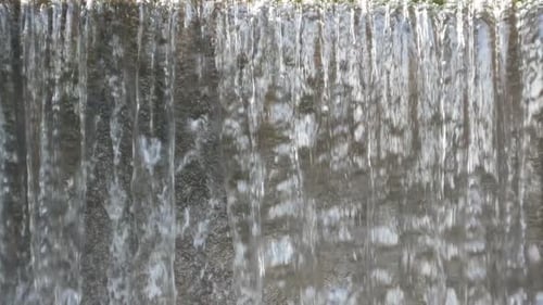 Water Cascading Down Natural Stone Wall