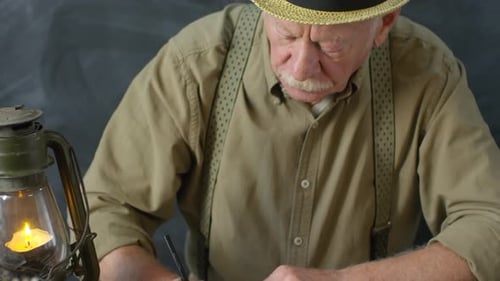 Portrait of Old-Fashioned Elderly Man Writing Poem