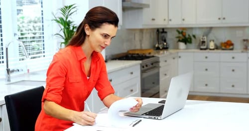 Woman Working from Home in Bright Kitchen