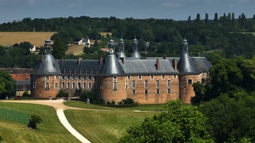 French Chateau Surrounded by Green Fields and Trees